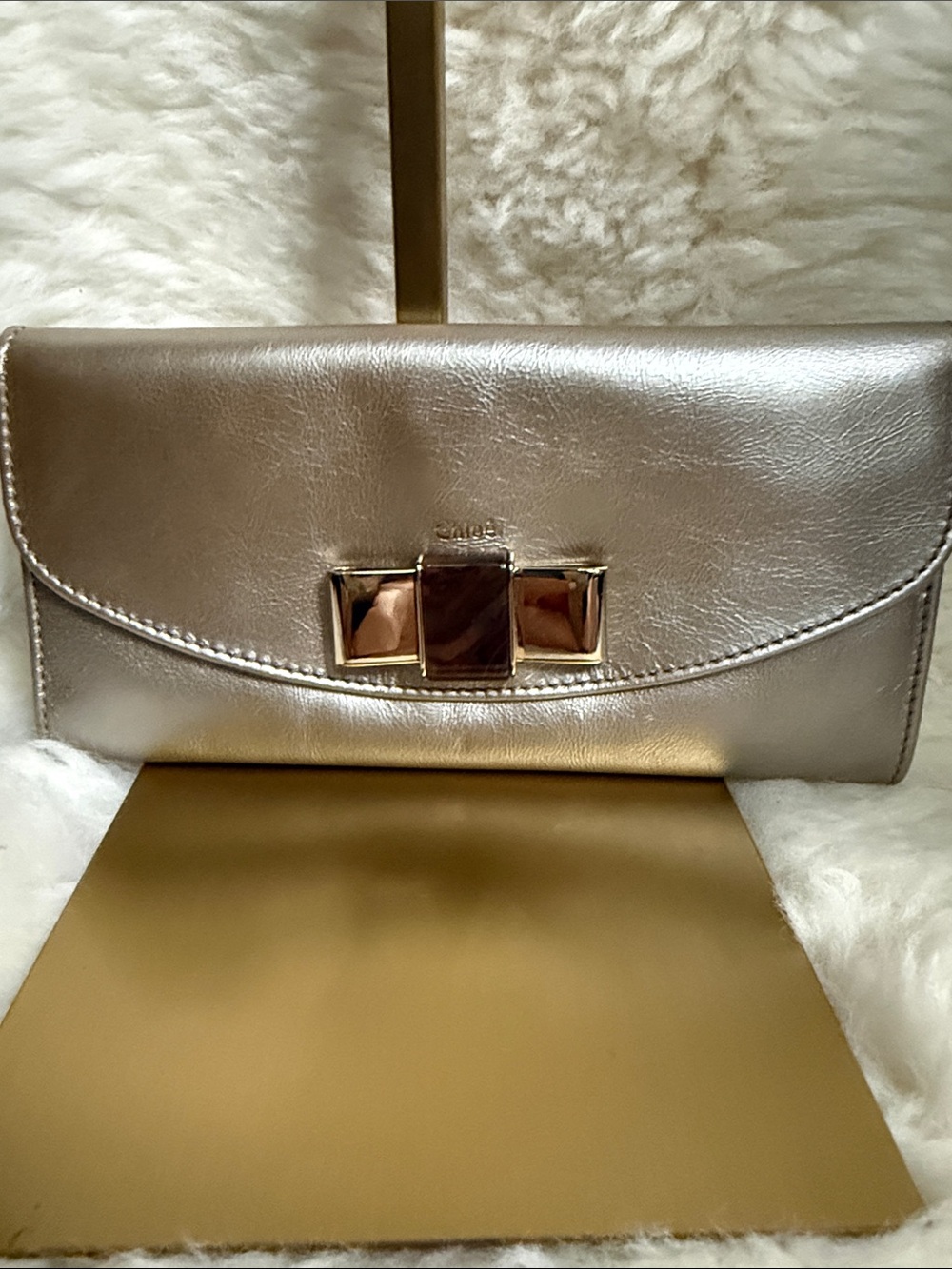 Chloe Metallic Silver Clutch with Gold-Tone Bow Accent Gorgeous